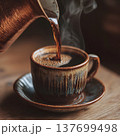 hot coffee being poured from a cezve (Turkish pot) into a ceramic cup, soft daylight, visible steam, wooden surface, 137699498