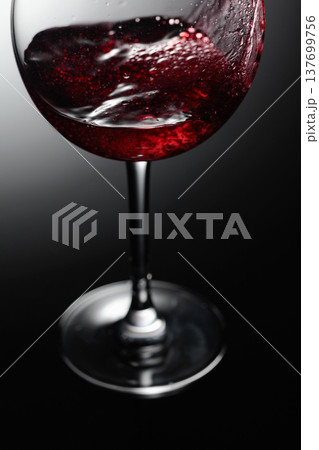 Closeup of red wine pouring. 137699756