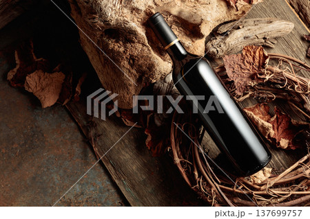 Bottle of red wine on a vintage rustic background. 137699757