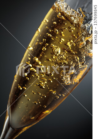 White sparkling wine is poured into a glass. White sparkling wine is poured into a glass. 137699845