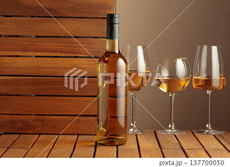 White wine on a wooden background. 137700050
