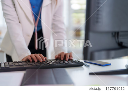 Professional adult hands typing keyboard computer data entry digital work office productivity modern workspace corporate environment 137701012