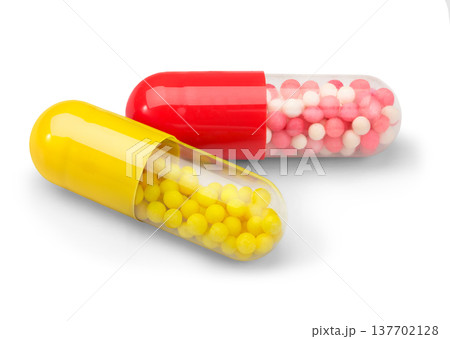Longacting capsules closeup with red and yellow microbeads 137702128