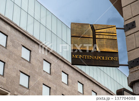Milan, italy, april 1, 2024. Montenapoleone street sign on a classical building facade, representing luxury shopping and fashion in the milan quadrilatero della moda Milan, italy, april 1, 2024. Montenapoleone street sign on a classical building facade, representing luxury shopping and fashion in the milan quadrilatero della moda 137704088