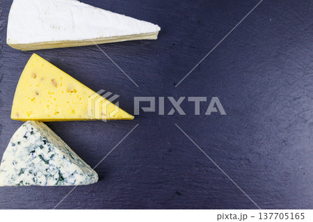 Set of various types of cheese on black slate background. Top view Set of various types of cheese on black slate background. Top view 137705165