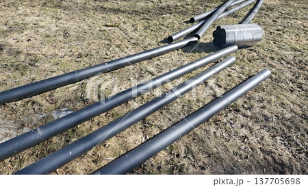 Plastic utility pipes on ground at construction site ready for pipeline installation Plastic utility pipes on ground at construction site ready for pipeline installation 137705698