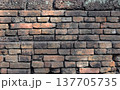The orange old brick wall of the ancient building 137705735
