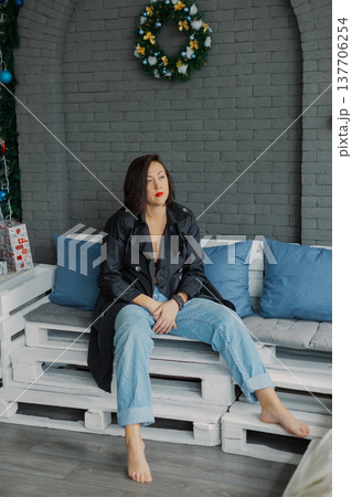 Woman posing for camera in photo studio on wooden Woman posing for camera in photo studio on wooden 137706254