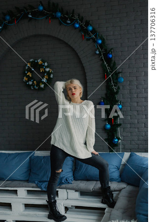 Woman posing for camera in photo studio on wooden 137706316