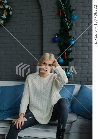 Woman posing for camera in photo studio on wooden Woman posing for camera in photo studio on wooden 137706322