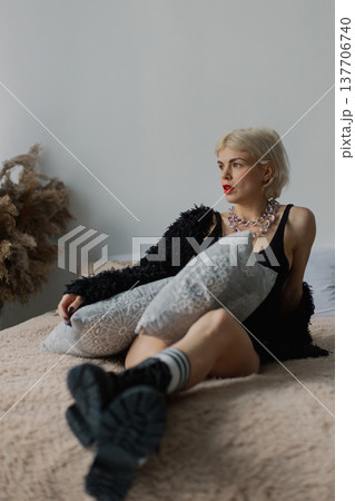 Beautiful woman posing for photographer on bed in Beautiful woman posing for photographer on bed in 137706740