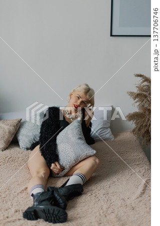 Beautiful woman posing for photographer on bed in Beautiful woman posing for photographer on bed in 137706746