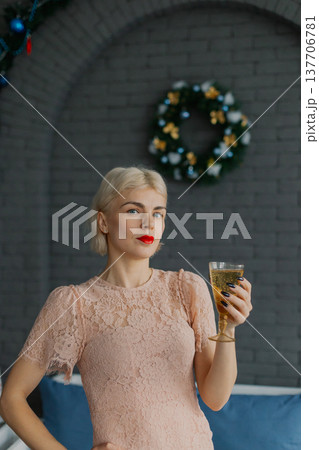 Woman with a glass of champagne in her hands 137706781