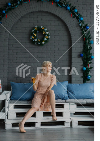 Woman posing for camera in photo studio on wooden Woman posing for camera in photo studio on wooden 137706790