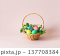 Easter painted eggs in a basket with flowers on pink background. Easter cute greeting card. Space for text. 137708384