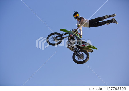 Motorcycle rider performing dangerous midair stunt trick in Almaty 137708596