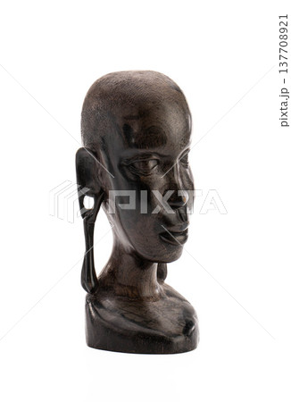 Sculpture of human head, African origin, weathered texture, serene gaze 137708921