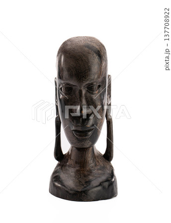 Abstract tribal head sculpture in dark wood, minimalist and serene Abstract tribal head sculpture in dark wood, minimalist and serene 137708922