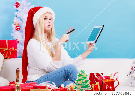 Girl with tablet credit card doing online shopping 137709840