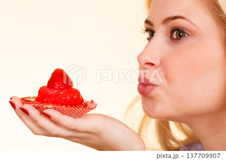 Woman holding sweet delicious cupcake Woman holding sweet delicious cupcake 137709907