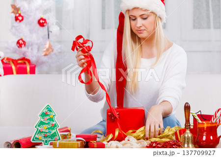 Young woman preparing gifts for Christmas Young woman preparing gifts for Christmas 137709927