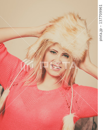Attractive woman wearing furry winter hat 137709961