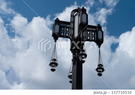 A tall pole with three signs hanging from it A tall pole with three signs hanging from it 137710510