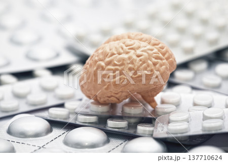 Human brain on heap of many various pills and tablets packs Human brain on heap of many various pills and tablets packs 137710624