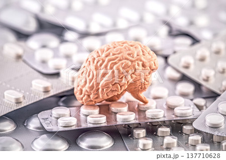 Human brain on heap of many various pills and tablets packs 137710628