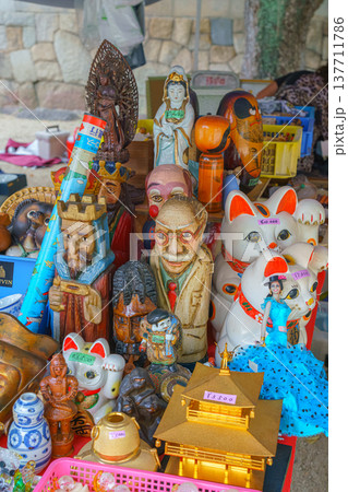 Osaka, Japan - Sep 21 2024, Close-up view of a counter with various antique toys and household items related to Japanese culture at flea market on territory of the Shitenno-ji Temple Osaka, Japan  137711786