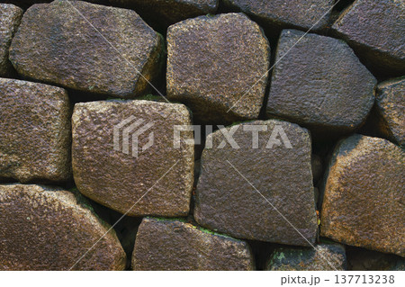 Osaka, Japan - Sep 22 2024, close up view of the old fortress wall consisting of large hewn stones, on the territory of Osaka Castle, Osaka, Japan Osaka, Japan - Sep 22 2024, close up view of the old fortress wall consisting of large hewn stones, on the territory of Osaka Castle, Osaka, Japan 137713238