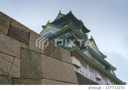 Osaka, Japan - Sep 22 2024, Panoramic view from below from behind the fortress wall to the facade of Osaka Castle, on a cloudy rainy day, without people, Osaka, Japan 137713253