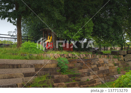 Osaka, Japan - Sep 22 2024, close up view A monument to the 32 victims, including Yodo-dono, a bronze sculpture of man in yellow clothes, without people, in park near by Osaka Castle, Osaka, Japan 137713270