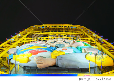 Osaka, Japan - Sep 22 2024, panoramic view from below of Don Quijote Dotonbori shopping and entertainment complex and Ferris wheel, in Dotonbori district, on canal corniche, at nighttime, Osaka, Japan Osaka, Japan - Sep 22 2024, panoramic view from below of Don Quijote Dotonbori shopping and entertainment complex and Ferris wheel, in Dotonbori district, on canal corniche, at nighttime, Osaka, Japan 137713408