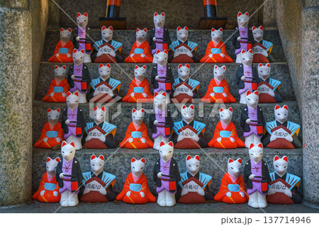 Kyoto, Japan - Sep 23 2024, A close-up view of the many small figures of white kitsune foxes dressed in traditional Japanese costumes at the Fushimi Inari Temple, at daytime, Kyoto, Japan 137714946