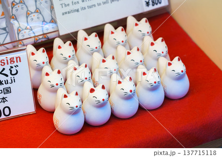 Kyoto, Japan - Sep 23 2024, Close up view of the many small figures of white foxes, kitsune, with red noses and ears, in the souvenir shop of Fushimi Inari Temple, Kyoto, Japan 137715118