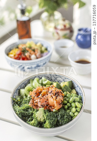 smoked salmon and green vegetable healthy poke bowl on white table in melbourne australia cafe smoked salmon and green vegetable healthy poke bowl on white table in melbourne australia cafe 137716059