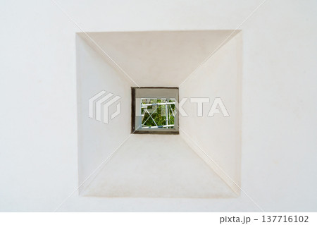 Himeji, Japan - Sep 24 2024, a close-up view of loophole in a form of square through which foliage of trees is visible, fortress wall of Himeji Castle, White Heron Castle, at daytime, Himeji, Japan Himeji, Japan - Sep 24 2024, a close-up view of loophole in a form of square through which foliage of trees is visible, fortress wall of Himeji Castle, White Heron Castle, at daytime, Himeji, Japan 137716102