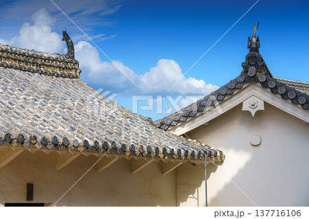 Himeji, Japan - Sep 24 2024, panoramic view of roofs decorated with tiles and sculptures sculptures of Shachihoko, a creature from Japanese folklore, White Heron Castle, with a blue sky, Himeji, Japan Himeji, Japan - Sep 24 2024, panoramic view of roofs decorated with tiles and sculptures sculptures of Shachihoko, a creature from Japanese folklore, White Heron Castle, with a blue sky, Himeji, Japan 137716106