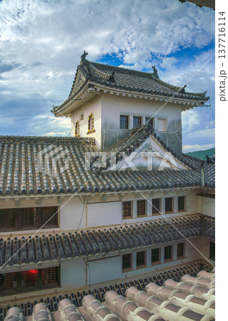 Himeji, Japan - Sep 24 2024, vertical, panoramic view from window of roofs and towers with roof tiles in courtyard of Himeji Castle, White Heron Castle, at daytime with cloudy sky, Himeji, Japan Himeji, Japan - Sep 24 2024, vertical, panoramic view from window of roofs and towers with roof tiles in courtyard of Himeji Castle, White Heron Castle, at daytime with cloudy sky, Himeji, Japan 137716114