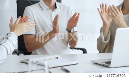 Business team applauding after achieving a goal during a productive meeting in a modern office environment, celebrating success and teamwork, close up Business team applauding after achieving a goal during a productive meeting in a modern office environment, celebrating success and teamwork, close up 137716703