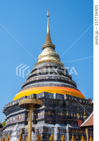 Vertical view of Wat Phra That Lampang Luang an iconic Buddhist temple was founded in the 13th century, One of the best examples of Lanna architecture in Lampang province of Thailand. Vertical view of Wat Phra That Lampang Luang an iconic Buddhist temple was founded in the 13th century, One of the best examples of Lanna architecture in Lampang province of Thailand. 137716905