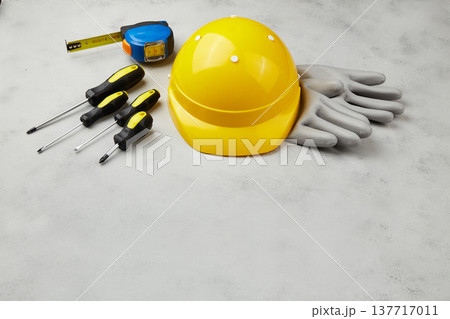 Happy labor day concept. Construction tools, yellow helmet on dark wooden background 137717011