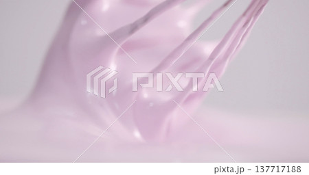 Mixing pink icing for cake decoration in a kitchen during the day 137717188