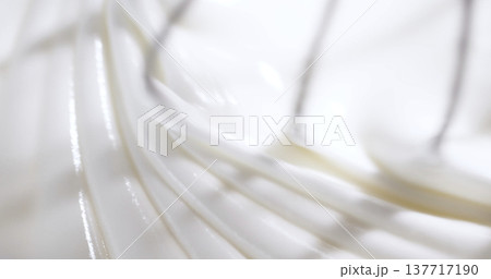 Whisk is moving in a bowl while making batter in a home kitchen during the early morning on a weekend 137717190