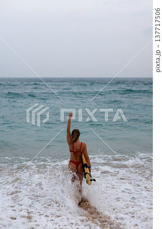 Surfer Waves Triumphs Energetically. Surfer Displays Triumphant Gesture Amid Crashing Waves And Spray 137717506