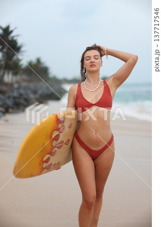 Serene Woman In Coral Swimwear. Serene Health Advocate With Layered Jewelry Enjoying Gentle Sea Breeze 137717546