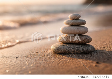 Balanced Stone Cairn on Quiet Beach at Sunset 137718315