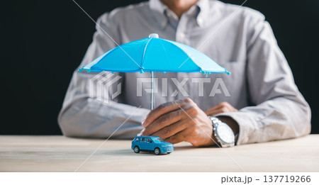 Person secures car insurance plan with umbrella coverage for auto vehicle, representing financial protection against accident damage, driver safety, and policy benefits for future travel claims Person secures car insurance plan with umbrella coverage for auto vehicle, representing financial protection against accident damage, driver safety, and policy benefits for future travel claims 137719266