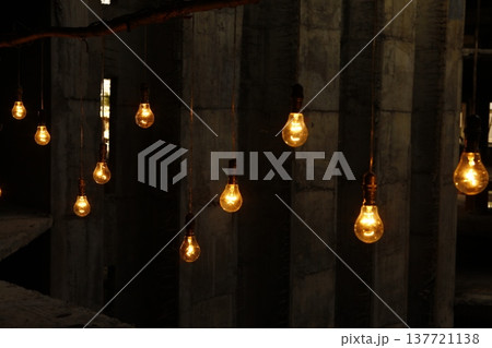 Old model Glow bulbs hanging in the dark at night 137721138